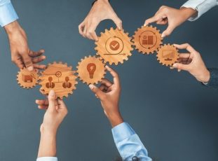 Hands,Gather,Around,Wooden,Gears,Featuring,Icons,Symbolizing,Teamwork,And